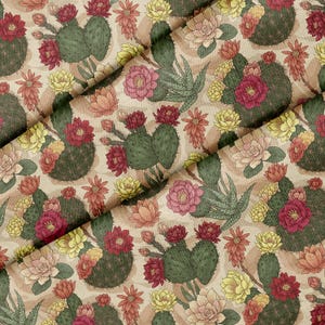 May include: A fabric featuring a repeating pattern of green cacti and blooming flowers in shades of red, pink, yellow, and orange on a light beige background. The design includes various cactus shapes and succulent-like plants with petals.