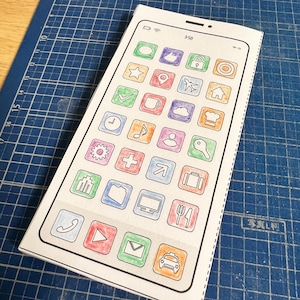 May include: A white smartphone mockup with a black outline and a variety of colorful icons on the screen. The icons include a speech bubble, a star, a checkmark, a clock, a music note, a gear, a plus sign, a bar graph, a folder, a computer monitor, a phone, a play button, an envelope, and a car.