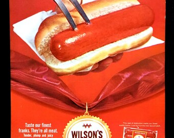 May include: An advertisement for Wilson's Certified All Meat Franks. A bright red hot dog in a bun is held with a fork. The ad features text that reads "Taste our finest franks. They're all meat. Tender, plump and juicy."
