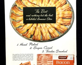 May include: Vintage advertisement featuring cooked bacon arranged on a silver platter. The text reads "The Best and nothing but the best is labeled Armour Star." Additional text highlights "Hand Picked," "Sugar Cured," and "Tender Smoked" bacon.