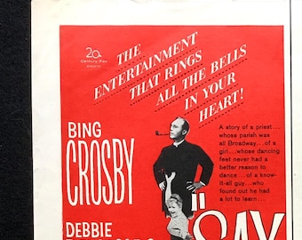 May include: A vintage movie poster for "Say One For Me" with Bing Crosby, Debbie Reynolds, and Robert Wagner. The red poster features the film's title and cast names in white, with stylized figures and text.
