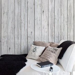 May include: White wood plank peel and stick wallpaper with a white sofa and black throw cushions. The text "NOUWALL PEEL & STICK REMOVABLE WALLPAPER" is visible at the bottom of the image.
