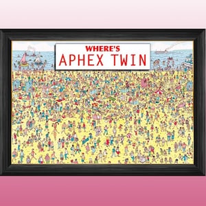 May include: A framed print of a "Where's Waldo" style illustration with the text "Where's Aphex Twin" at the top. The image features a crowded beach scene with many people in various poses and clothing.
