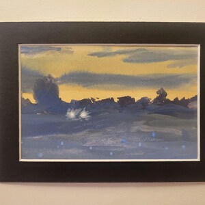 May include: A framed watercolor painting depicting a landscape with a blue and yellow sky, a dark blue foreground, and white highlights.