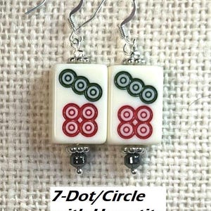 May include: Pair of white rectangular earrings featuring a 7-dot/circle design in red and green, with hematite beads. The earrings have silver-coloured hooks. Text reads "7-Dot/Circle with Hematite".