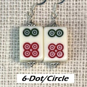 May include: Earrings with rectangular white tiles, each displaying red and green circular patterns. The earrings have silver hooks and decorative elements. The text "6-Dot/Circle" is visible at the bottom of the image.