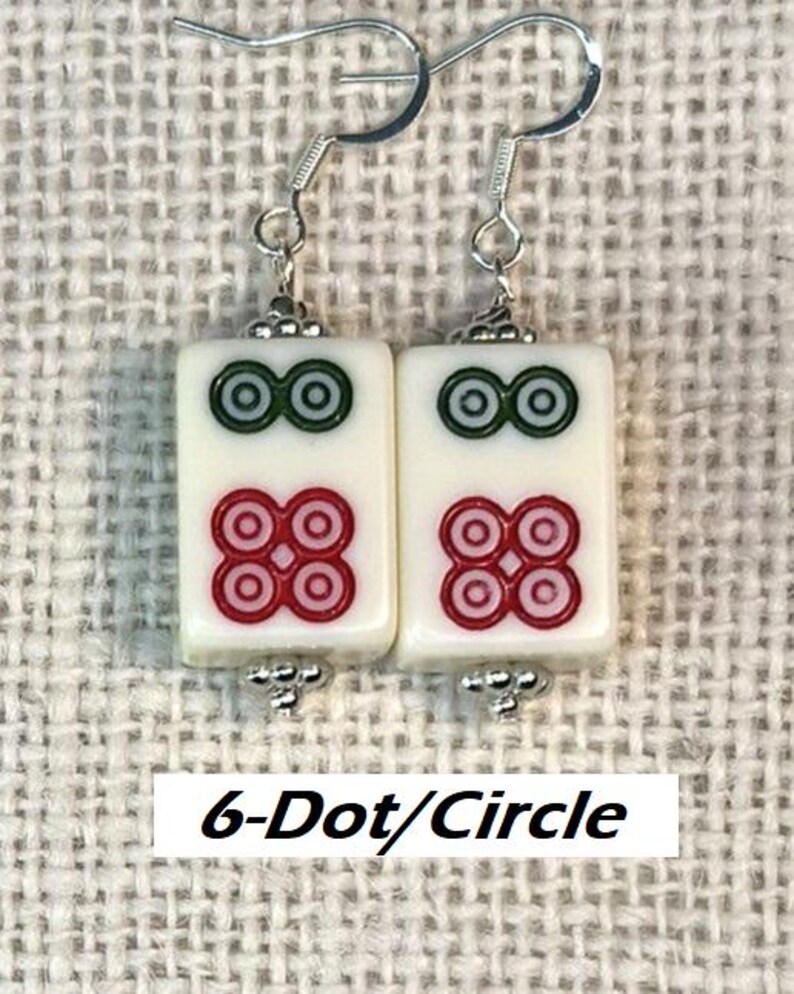 May include: Earrings with rectangular white tiles, each displaying red and green circular patterns. The earrings have silver hooks and decorative elements. The text "6-Dot/Circle" is visible at the bottom of the image.