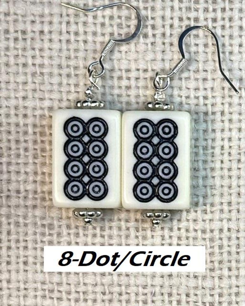 May include: Earrings featuring a white rectangular tile design with a black 8-dot circle pattern. The earrings have silver-tone hooks and decorative elements. The text "8-Dot/Circle" is visible at the bottom of the image.