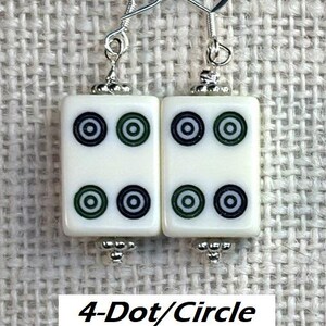 May include: White rectangular earrings featuring four black and green circle designs. The earrings have silver-coloured hooks and decorative beads. The text "4-Dot/Circle" is at the bottom of the image.