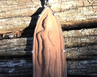 This is  a ceramic, Thai Classical Dancer amulet, set in Sterling Silver.