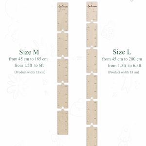 May include: Two wooden growth charts with the text "Anderson Family" at the top. The chart on the left is labelled "Size M" and measures from 45 cm to 185 cm (1.5 ft to 6 ft). The chart on the right is labelled "Size L" and measures from 45 cm to 200 cm (1.5 ft to 6.5 ft).