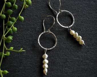 Sterling silver circle earrings with freshwater pearl dangles. Modern white pearl hoops, unique pearl jewellery, rice pearl silver earrings