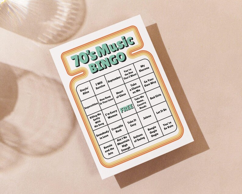 May include: A retro-style bingo card with the text "70's Music BINGO" in a teal and orange design. The card features a grid with song titles from the 1970s, including "Stayin' Alive" and "Jolene". The card is on a neutral background.