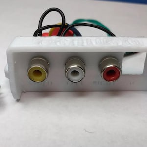 May include: A white plastic box with three RCA jacks, one yellow, one white, and one red. A black power connector is also visible.