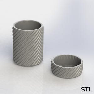 May include: A gray, cylindrical container and a smaller, matching round container. Both have a textured, diagonal grooved pattern. The larger container is upright, while the smaller one is beside it. The letters "STL" are in the bottom right corner.
