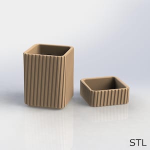 May include: Two beige, square containers. The larger one is tall and rectangular, with vertical ridged detailing. The smaller container is a shorter, square version of the larger one, also with ridged detailing. The word "STL" is in the bottom right corner.