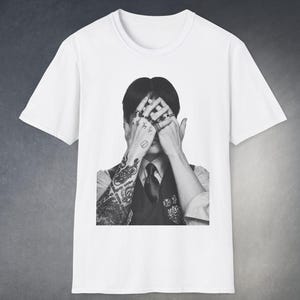 May include: A set of three ceramic mugs with a speckled, matte finish. The mugs are in shades of cream, light gray, and dark gray. Each mug has a simple, modern design and a rounded handle.