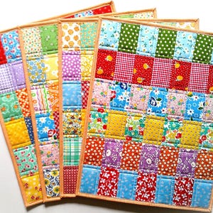 May include: A set of three ceramic mugs with a speckled, matte finish. The mugs are in shades of cream, light gray, and dark gray. Each mug has a simple, minimalist design, perfect for coffee or tea.