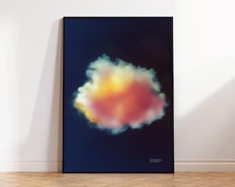 May include: A framed art print featuring a vibrant cloud formation against a dark blue background. The cloud is a blend of yellow, orange, and white hues. The print is displayed on a wooden floor.