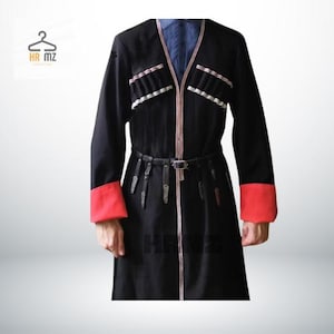 May include: A black long-sleeved coat with red trim on the cuffs and a black leather belt. The coat has a decorative white and black trim around the neckline and down the front.