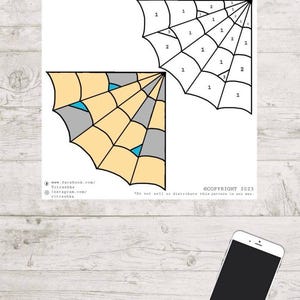 May include: A printed craft pattern with a spiderweb design, divided into numbered segments. The design incorporates light yellow, grey, and teal sections. The image also includes the text "©COPYRIGHT 2023" and social media handles.
