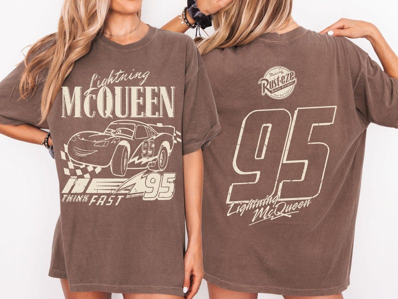 May include: Brown t-shirt with Lightning McQueen graphics. The front features the car, text "Lightning McQueen," and "Think Fast." The back displays a "Rusteze" logo and the number "95" with "Lightning McQueen."