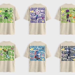 May include: Six beige t-shirts with superhero graphics. Designs include Hulk, Ghost Spider, Green Goblin, Electro, Captain America, and Black Panther. Each shirt features character names and imagery in vibrant colors.