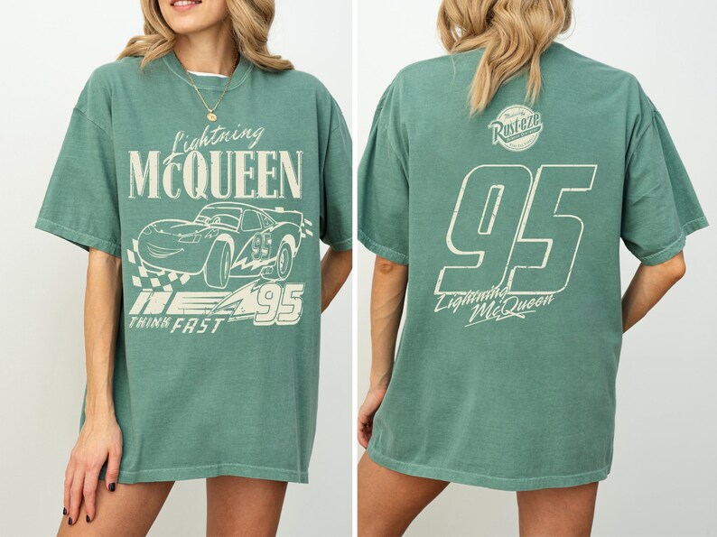 May include: Green Lightning McQueen t-shirt with a distressed white graphic on the front and back. The front features the text "Lightning McQueen", a car illustration, and "95". The back displays "95" and "Lightning McQueen".