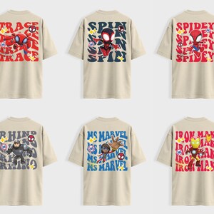 May include: Six beige t-shirts with Marvel character designs. The shirts feature characters like Spider-Man, Rhino, and Iron Man, with text overlays such as "TRACE", "SPIN", and "SPIDEY". Each design is colorful and cartoon-like.