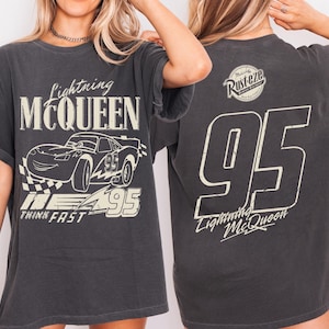 May include: Dark grey Lightning McQueen t-shirt. The front displays a graphic of the character and the text "Lightning McQueen", "95", and "Think Fast". The back of the shirt shows the number "95", the text "Lightning McQueen", and a "Rusteze" logo.