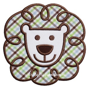 May include: Embroidered lion face design with a brown, green, and blue plaid pattern. The lion has a white face with brown eyes, nose, and mouth.