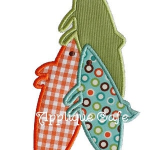 May include: Three embroidered fish in a stack, the top fish is green, the middle fish is orange and white checkered, and the bottom fish is blue and white polka dotted.