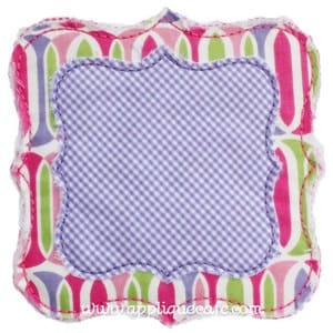 May include: A square-shaped applique with a pink, green, and purple geometric pattern. The applique has a scalloped edge and a white background. The applique is perfect for adding a touch of whimsy to any project.