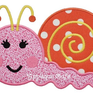 May include: A pink and orange snail applique with a swirl pattern on the shell and a smiling face with eyelashes. The snail has yellow antennae and a pink body.