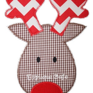 May include: Red and white chevron reindeer applique with brown gingham fabric and a red nose. The applique has a stitched edge.