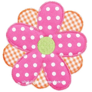 May include: A pink flower with white polka dots and a green center. The flower is surrounded by a layer of orange and white gingham fabric.