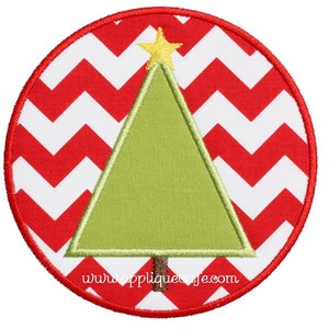 May include: A green Christmas tree with a yellow star on top, on a red and white chevron background. The tree is in a circle with a red border. The text "www.appliquecafe.com" is at the bottom of the circle.