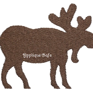May include: Brown felt applique of a moose with large antlers. The applique is a simple silhouette with no details. The text "Applique Cafe" is visible in the lower center of the image.