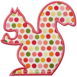 May include: Pink applique of a squirrel with a white background and colorful polka dots. The applique has a website address at the bottom.