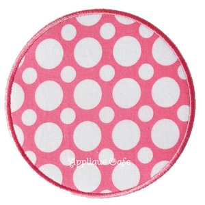 May include: Pink fabric circle with white polka dots and the text "Applique Cafe" in white.