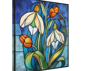 Könnte beinhalten: Gerahmtes Buntglas-Kunstwerk mit Schneeglöckchen und orangefarbenen Knospen vor blauem Hintergrund. Der schwarze Rahmen betont die filigranen Details des Glases und das Spiel des Lichts.