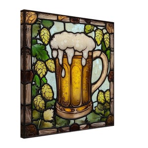 May include: A stained glass artwork featuring a large beer mug overflowing with foamy beer. The mug is surrounded by green hops and leaves, set against a light blue background. The artwork is framed in a dark brown border.