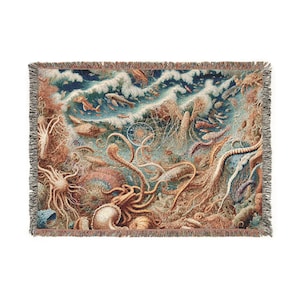 May include: Woven throw blanket featuring an intricate underwater scene with marine life, including fish, octopuses, and coral. The design incorporates shades of blue, brown, and beige, with a fringed border. The blanket is rectangular and suitable for home decor.