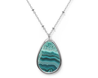May include: A silver chain necklace with a teardrop-shaped pendant featuring a blue and green agate stone.