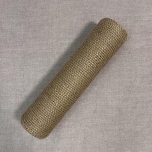 May include: A long, brown, rope-wrapped cylinder. The rope is tightly wound and has a natural, rustic look.