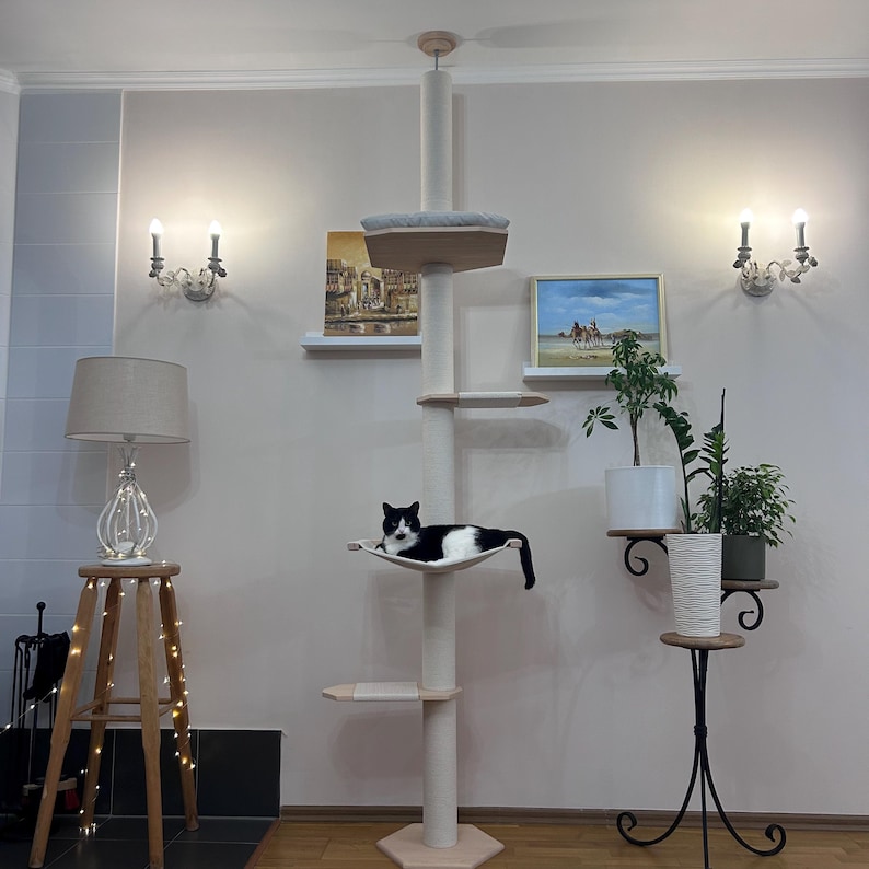Eco-friendly tall cat tree with hammock and bed, crafted from natural wood and designed with adjustable height, durable cotton-wrapped scratching posts, spacious platforms, and soft cushions, perfect for large cats and modern interiors