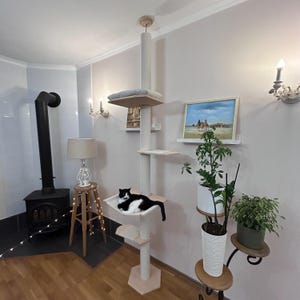 Tall cat tower with hammock and bed, eco-friendly modern cat furniture made of natural wood, features adjustable height, cotton-wrapped scratching posts, and spacious platforms, perfect for large cats to relax, climb, and play indoors