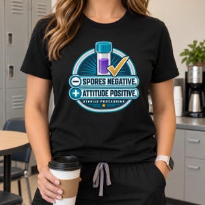 May include: A black short-sleeved t-shirt featuring a graphic with a test tube, a checkmark, and the text: SPORES NEGATIVE. ATTITUDE POSITIVE. STERILE PROCESSING. The design uses blue, white, and yellow colors in a circular emblem.