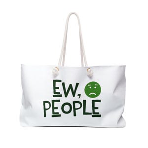 May include: A white tote bag with two white rope handles. The front features the dark green text "EW, PEOPLE" in a hand-drawn style font, accompanied by a dark green circular icon depicting a sad face with a downturned mouth and two eyes.