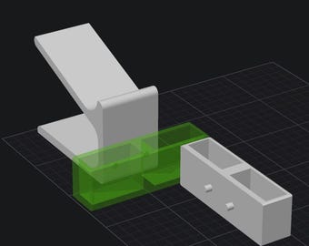 May include: A white phone stand with a green and white storage box with two compartments. The storage box is attached to the phone stand.